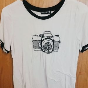 White shirt with black camera sewing design